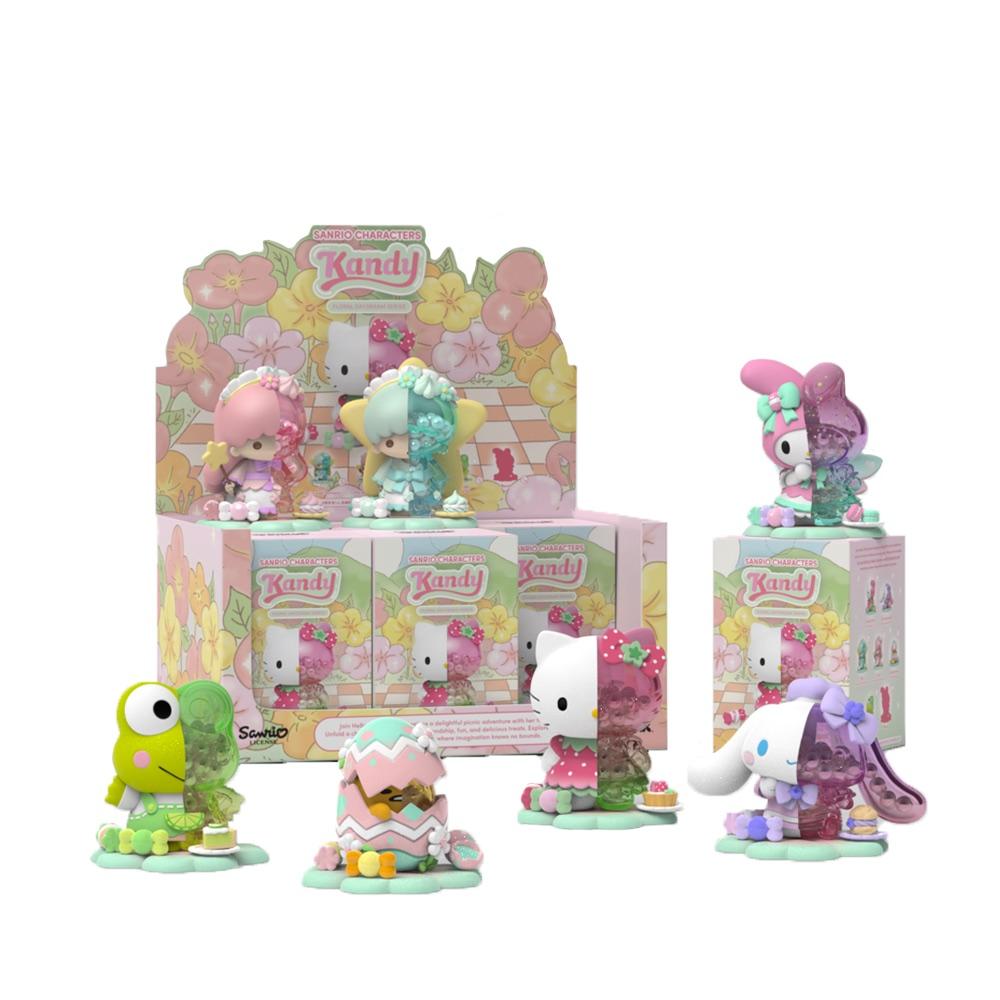 Sanrio Kandy collectible figures in pastel colors, including Hello Kitty, Cinnamoroll and My Melody, in front of a floral display box