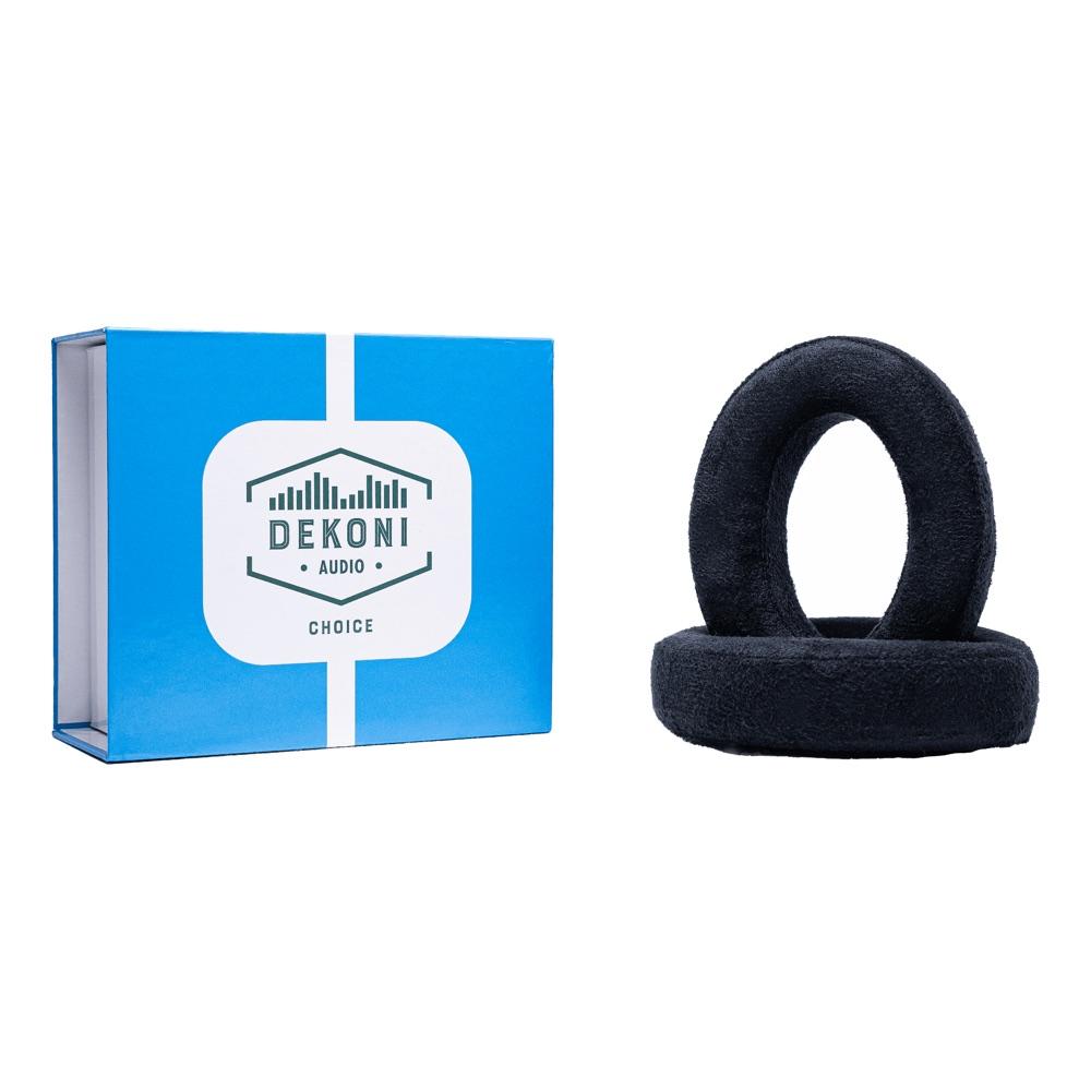 Pair of black Dekoni Choice suede ear pads beside their blue and white Dekoni Audio gift box, on a white background