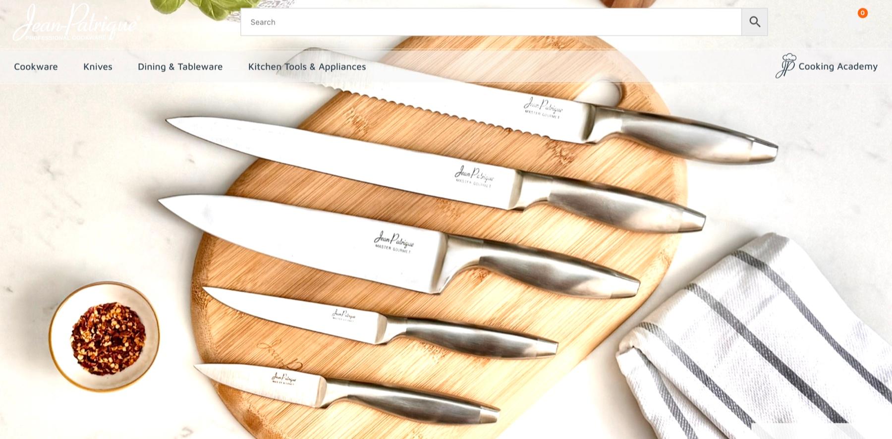Jean Patrique storefront with a banner about a 100-day money-back guarantee, a search bar, the menu Cookware, Knives, Dining and Tableware, Kitchen Tools and Appliances and Cooking Academy, and a set of five knives on a bamboo board