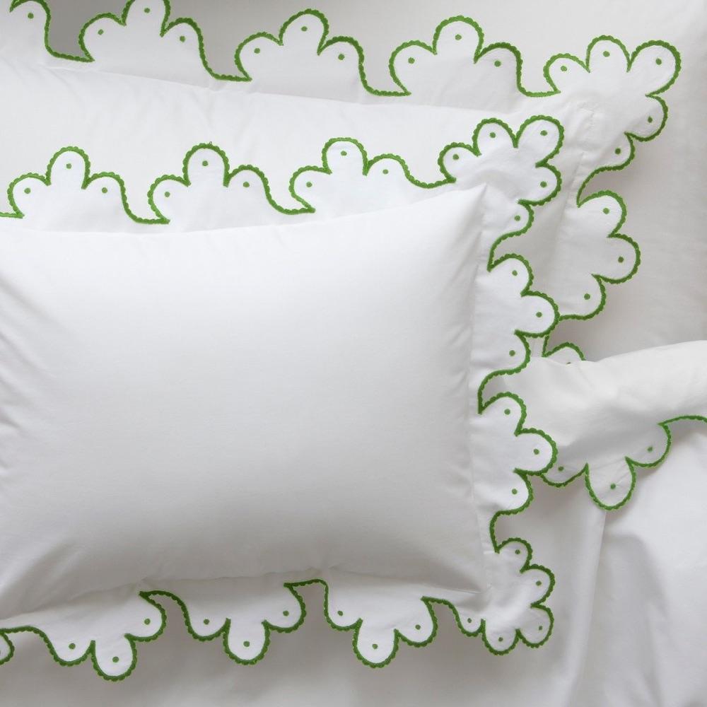 Calais bed linens in white with a green scalloped embroidered edge