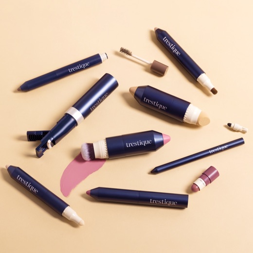 Flat lay of eight Trestique navy makeup pieces